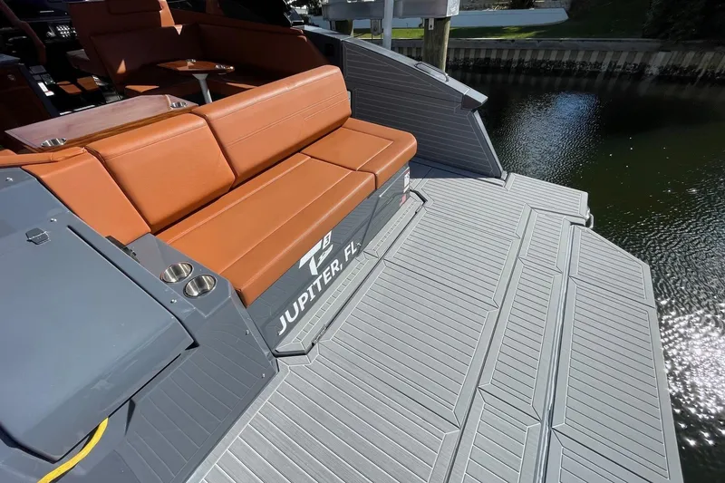 Slide: The Image of 2023 Cruisers Yachts 38 GLS I/O with brown seating and spacious deck by the water. - 36
