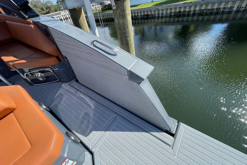 Slide: The Image of 2023 Cruisers Yachts 38 GLS I/O deck with orange seating by water. - 37