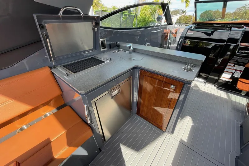 Slide: The Image of 2023 Cruisers Yachts 38 GLS I/O boat interior with kitchenette and seating area. - 38