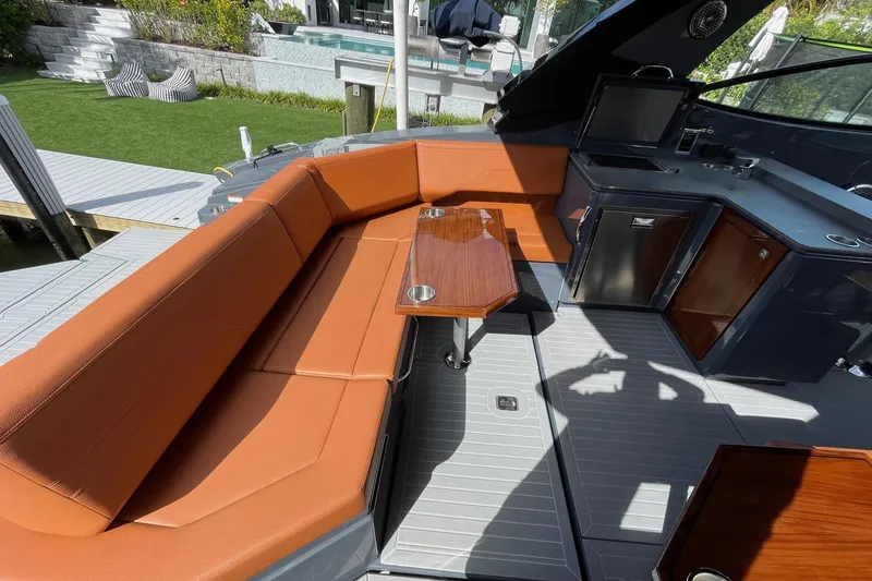 Slide: The Image of 2023 Cruisers Yachts 38 GLS I/O interior with orange seating and kitchenette. - 39