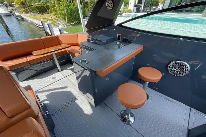 Slide: The Image of 2023 Cruisers Yachts 38 GLS I/O interior with seating and bar area by the water. - 42