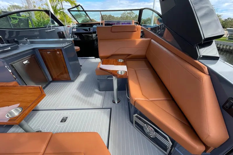 Slide: The Image of 2023 Cruisers Yachts 38 GLS I/O interior with tan seating and sleek cabinetry. - 45