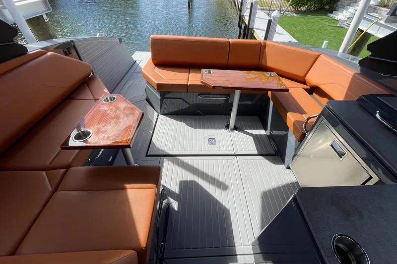 Slide: The Image of 2023 Cruisers Yachts 38 GLS I/O interior with luxurious seating and tables. - 47