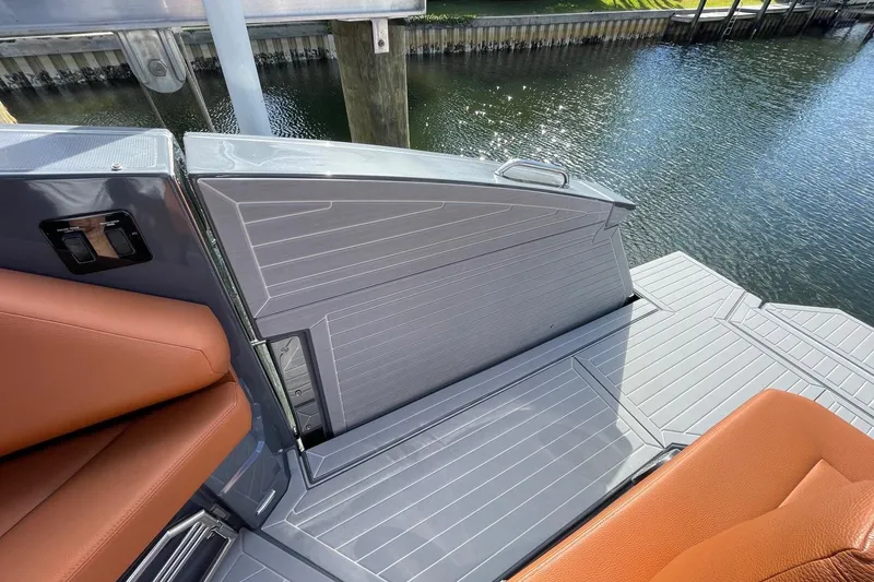 Slide: The Image of 2023 Cruisers Yachts 38 GLS I/O boat deck with brown seating and water view. - 49