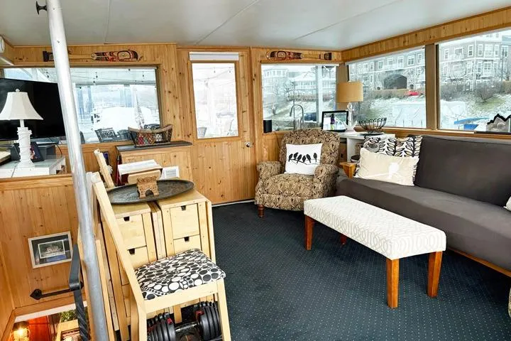 Slide: The Image of Cozy interior of 1987 Kelly motor yacht with wooden paneling and comfortable seating. - 11