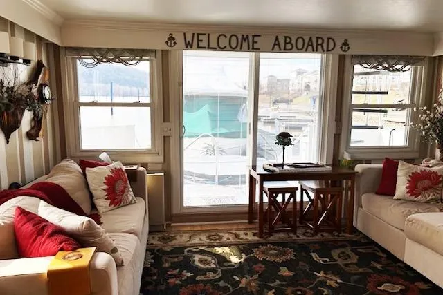 Slide: The Image of Interior of 1987 Kelly motor yacht with cozy seating and "Welcome Aboard" sign. - 16