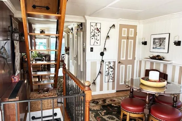 Slide: The Image of Interior of 1987 Kelly motor yacht with wooden stairs, dining area, and decorative accents. - 17