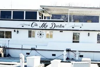 Slide: The Image of 1987 Kelly motor yacht "Oh My Darlin'" docked at a marina. - 2