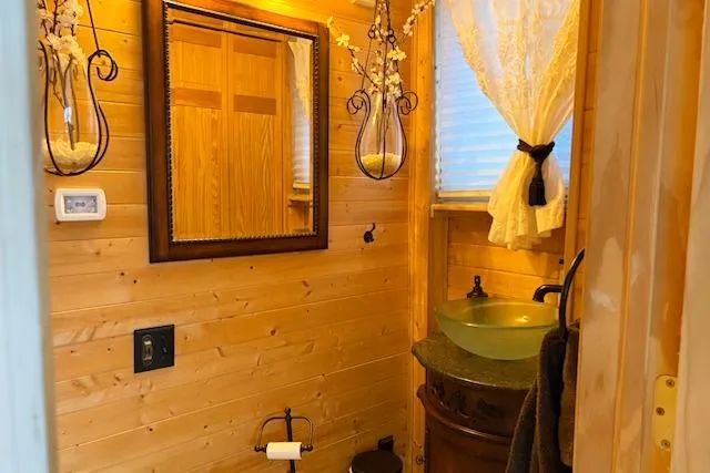 Slide: The Image of Cozy wooden bathroom on 1987 Kelly motor yacht with glass sink and decorative lighting. - 23