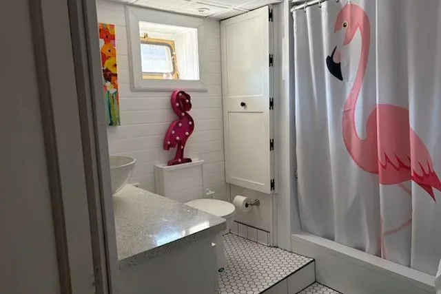 Slide: The Image of Bathroom in 1987 Kelly motor yacht with flamingo decor and hexagonal tile flooring. - 31