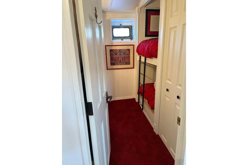 Slide: The Image of Interior of 1987 Kelly motor yacht with bunk beds and red carpet. - 35