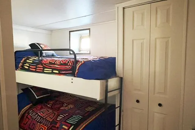 Slide: The Image of Bunk beds in 1987 Kelly motor yacht cabin with colorful bedding and closet. - 36