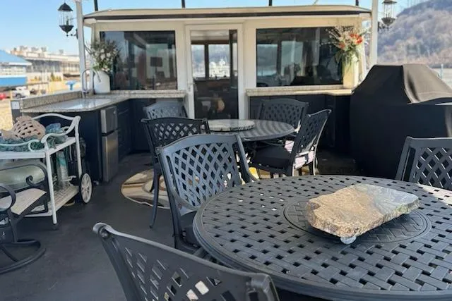 Slide: The Image of Outdoor seating area on a 1987 Kelly motor yacht with tables and chairs. - 37