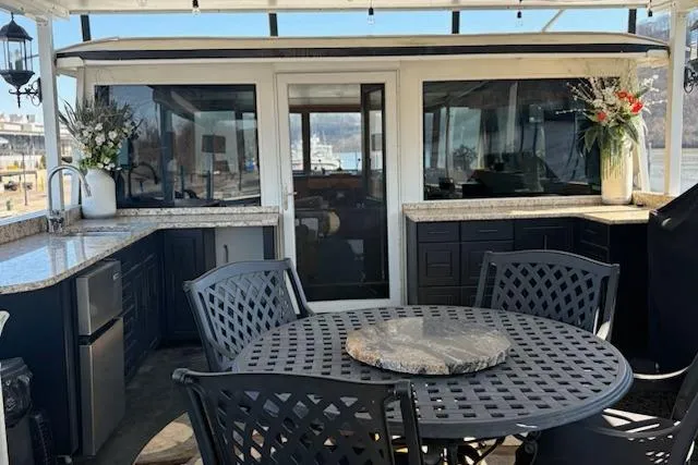 Slide: The Image of Luxurious 1987 Kelly motor yacht with elegant outdoor dining area and modern kitchen amenities. - 38