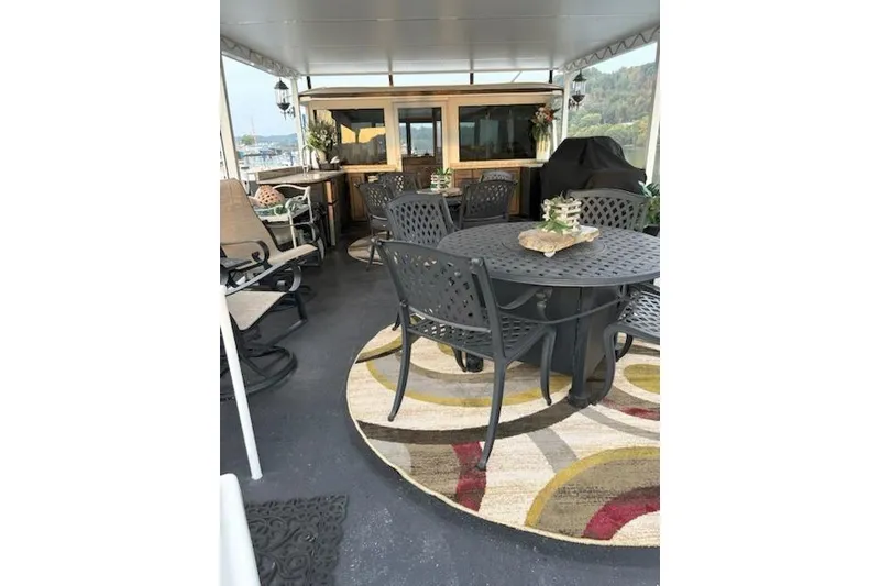 Slide: The Image of Spacious deck of 1987 Kelly motor yacht with outdoor seating and decor. - 39