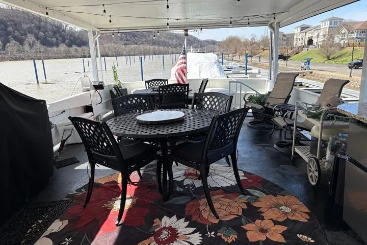 Slide: The Image of Outdoor seating area on 1987 Kelly motor yacht with floral rug and river view. - 41