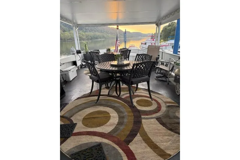 Slide: The Image of Outdoor seating area on 1987 Kelly motor yacht with scenic river view. - 42