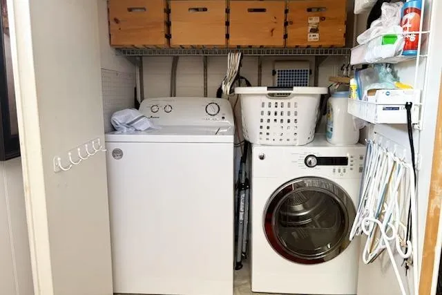 Slide: The Image of Laundry area on a 1987 Kelly motor yacht with washer, dryer, and storage. - 43