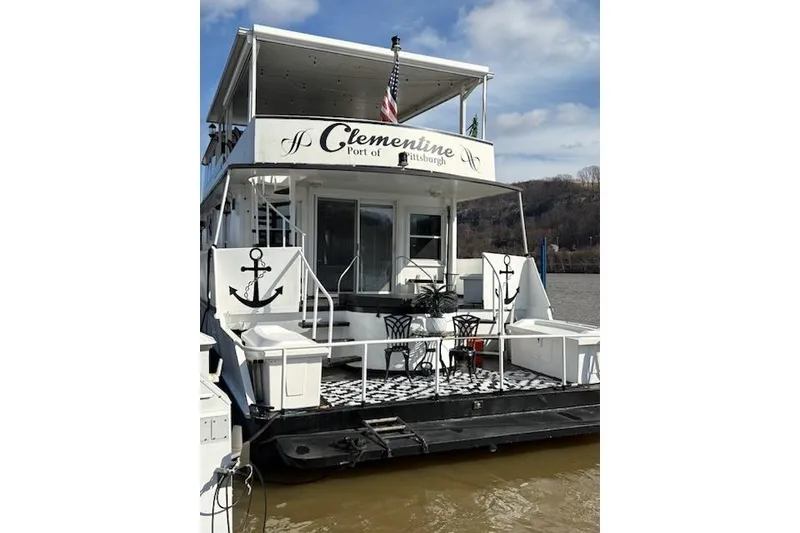 Slide: The Image of 1987 Kelly motor yacht "Clementine" docked, featuring a stylish deck with anchor decor. - 5