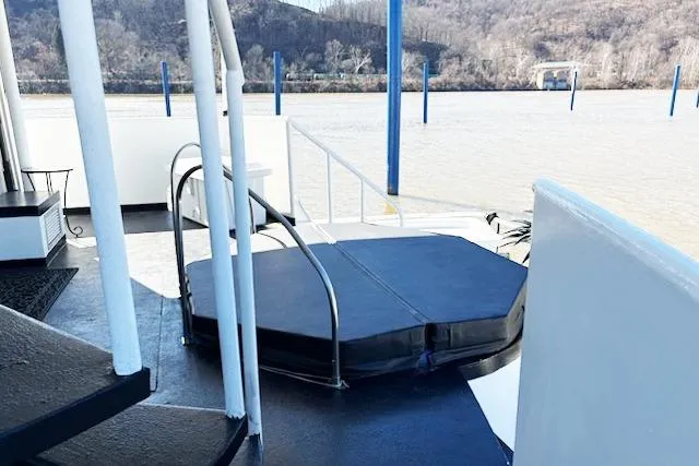 Slide: The Image of 1987 Kelly motor yacht deck with hot tub, overlooking serene river and wooded hills. - 6