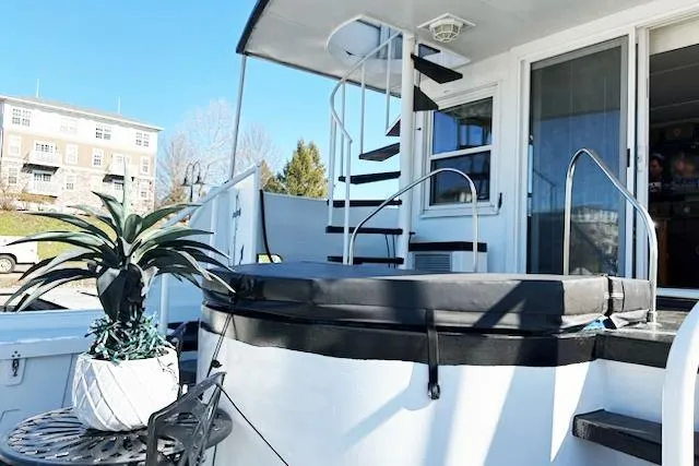 Slide: The Image of 1987 Kelly motor yacht with spiral staircase and outdoor seating area. - 8