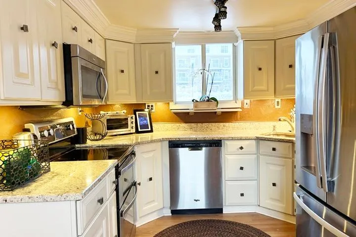 Slide: The Image of Modern kitchen with stainless steel appliances and white cabinets on a 1987 Kelly motor yacht. - 9