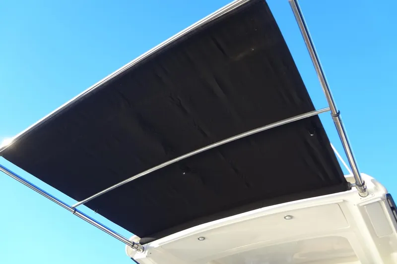 Slide: The Image of 2017 Sea Ray Sundancer 350 boat canopy against clear blue sky. - 18