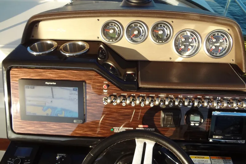 Slide: The Image of 2017 Sea Ray Sundancer 350 dashboard with navigation system and gauges. - 26