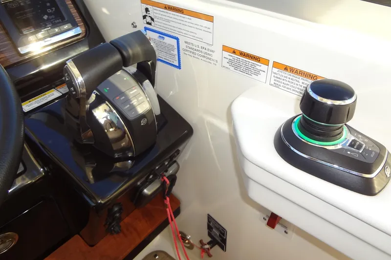 Slide: The Image of Control panel of 2017 Sea Ray Sundancer 350 with throttle and joystick controls. - 29