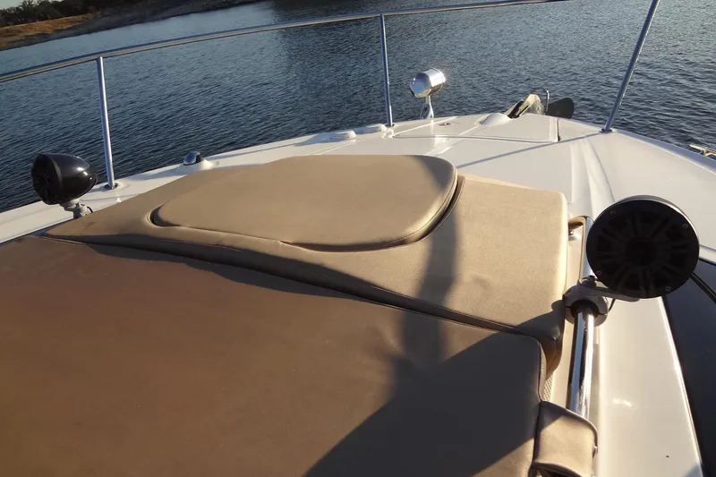 Slide: The Image of 2017 Sea Ray Sundancer 350 boat deck with sun pad, speakers, and water view. - 38