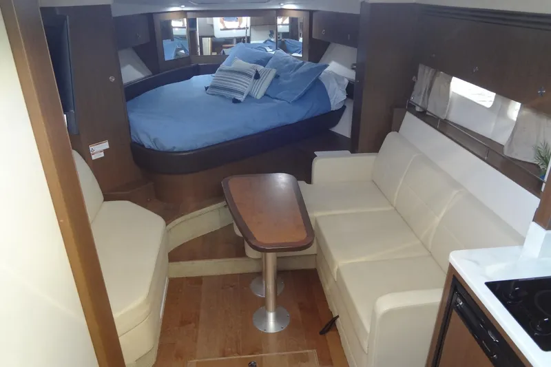 Slide: The Image of 2017 Sea Ray Sundancer 350 interior with cozy seating, table, and bed. - 39
