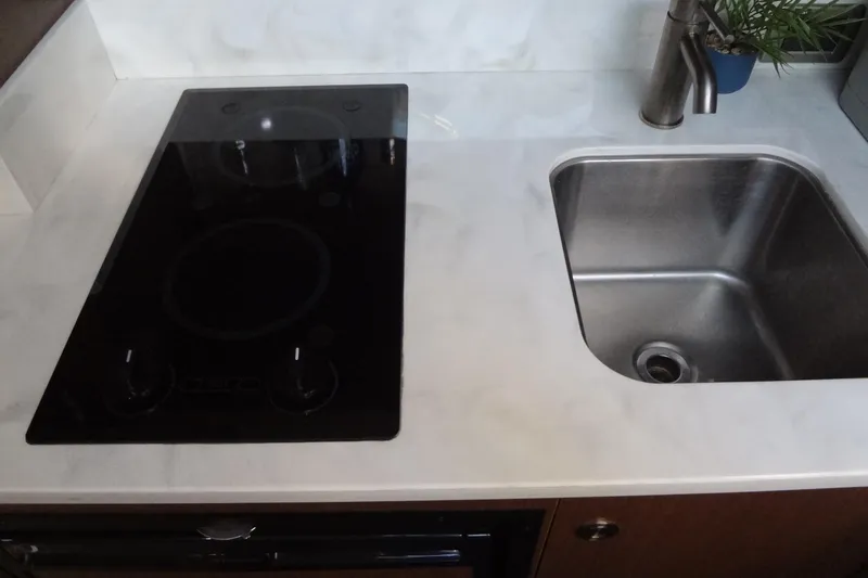 Slide: The Image of Modern kitchen area in 2017 Sea Ray Sundancer 350 yacht with stove and sink. - 45