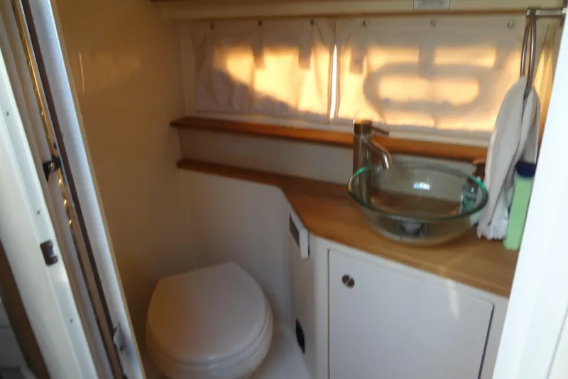 Slide: The Image of 2017 Sea Ray Sundancer 350 bathroom with modern sink and toilet. - 50