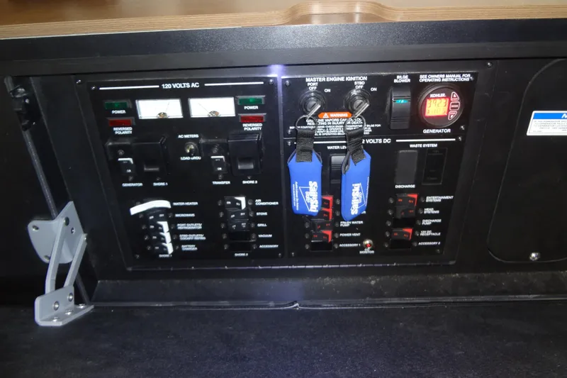 Slide: The Image of Electrical control panel of 2017 Sea Ray Sundancer 350 boat, featuring various switches and meters. - 52