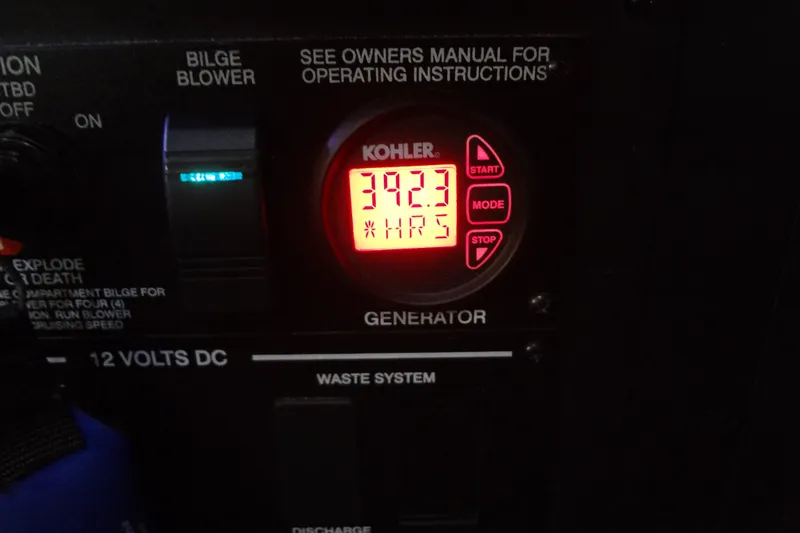 Slide: The Image of Control panel of a 2017 Sea Ray Sundancer 350, featuring a Kohler generator display. - 53