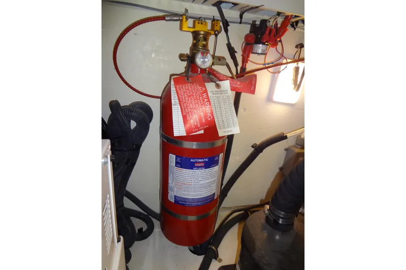 Slide: The Image of Fire extinguisher in 2017 Sea Ray Sundancer 350 engine room, with safety tags and wiring. - 59