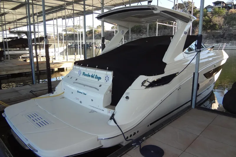 Slide: The Image of 2017 Sea Ray Sundancer 350 docked in a marina, covered and ready for use. - 62