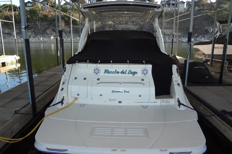 Slide: The Image of 2017 Sea Ray Sundancer 350 docked, rear view with cover, in a marina setting. - 63