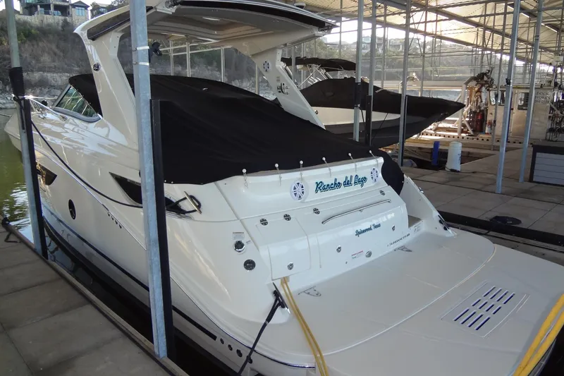 Slide: The Image of 2017 Sea Ray Sundancer 350 docked in a marina, covered and ready for use. - 64
