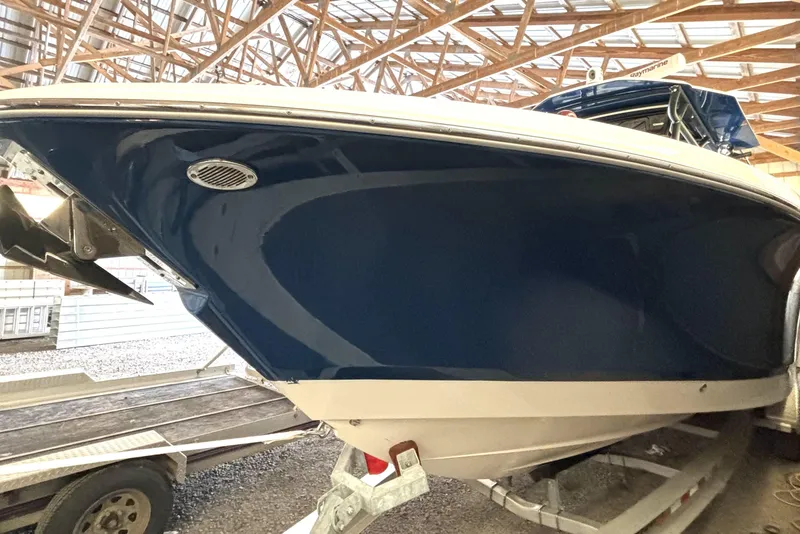 Slide: The Image of 2019 Wellcraft 302 Fisherman boat in storage, showcasing sleek blue hull design. - 10