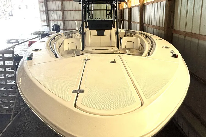 Slide: The Image of 2019 Wellcraft 302 Fisherman boat in storage, showcasing spacious deck and seating. - 12