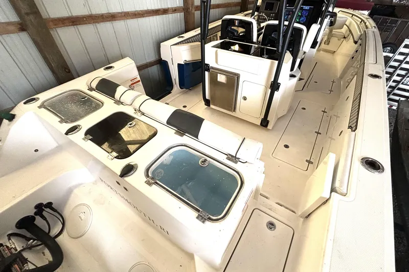 Slide: The Image of 2019 Wellcraft 302 Fisherman boat interior with seating and storage compartments. - 13