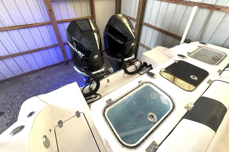 Slide: The Image of 2019 Wellcraft 302 Fisherman boat with dual Mercury outboard engines in a storage shed. - 14
