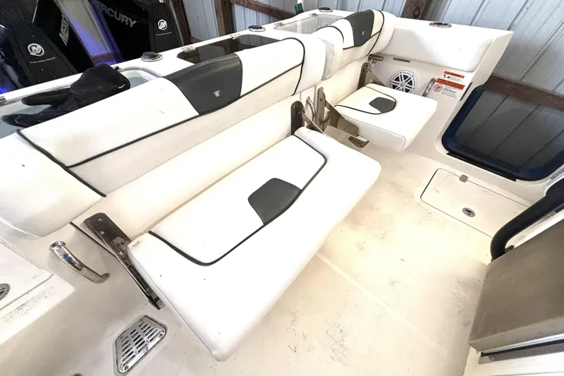 Slide: The Image of 2019 Wellcraft 302 Fisherman boat interior with white seating and storage compartments. - 16