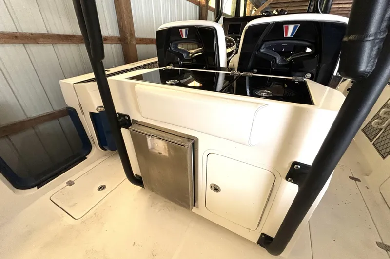 Slide: The Image of 2019 Wellcraft 302 Fisherman boat interior with dual seats and storage compartments. - 18