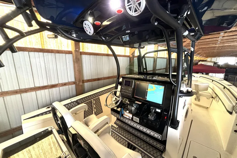 Slide: The Image of 2019 Wellcraft 302 Fisherman boat interior with advanced navigation system and dual seating. - 21