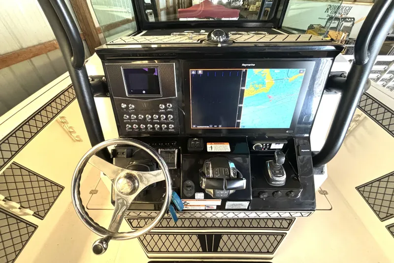 Slide: The Image of 2019 Wellcraft 302 Fisherman dashboard with navigation and control systems. - 23