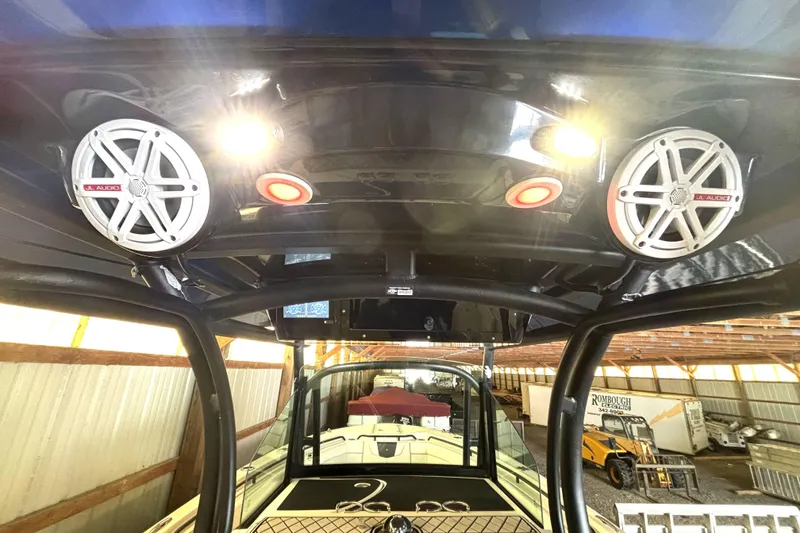 Slide: The Image of 2019 Wellcraft 302 Fisherman boat interior with JL Audio speakers and overhead lighting. - 27