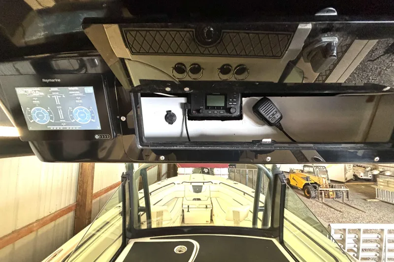 Slide: The Image of 2019 Wellcraft 302 Fisherman boat dashboard with Raymarine display and communication equipment. - 28