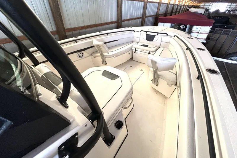 Slide: The Image of 2019 Wellcraft 302 Fisherman boat interior with white seating and storage compartments. - 30
